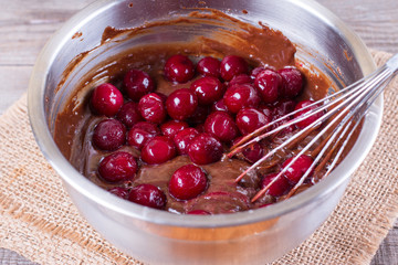 Cherries and chocolate dough in a bowl