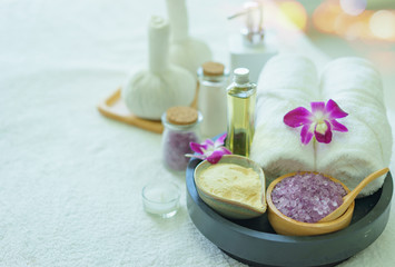 Obraz na płótnie Canvas Beauty and fashion concept with spa set.Spa feet and hand thai massage compress balls,herbal ball on the wooden with treatments spa,summer day,Thailand.