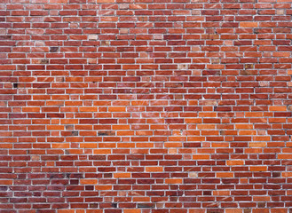 part of wall masonry with bright red old bricks