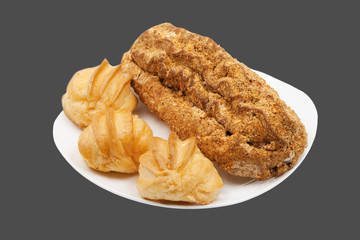 Cake eclair on a white plate