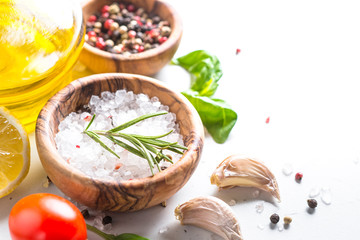 Obraz na płótnie Canvas Spices, herbs and olive oil over white stone table.