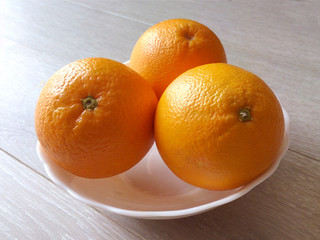 Oranges on a plate of ripe juicy fragrant fruit the key to a good health and mood vitamins citrus a pleasant start