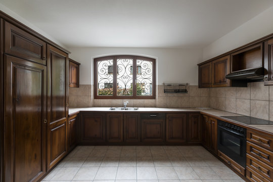 Elegant dark wood kitchen with window