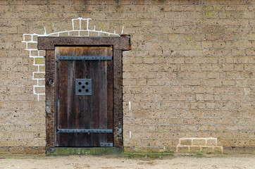 old wooden door closeup, front view, brick wall