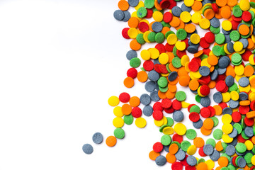 Colorful sweet confetti topping on white background with copy space at the left side