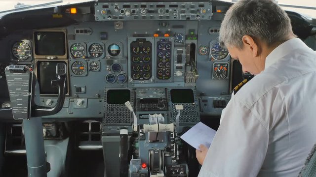The pilot prepares to flight and checks some documents