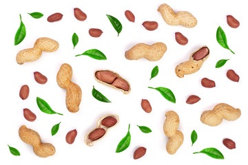 Peanuts decorated with green leaves isolated on white background, top view. Flat lay pattern