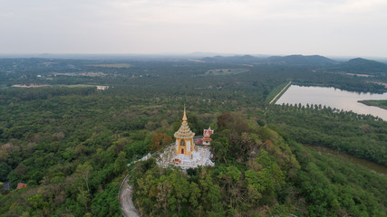 Fototapeta na wymiar Aerial drone view of small temple on the green hill in Thailand