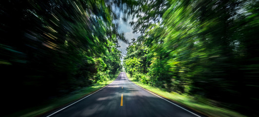 Empty asphalt road and speed motion blur on highway in summer with green trees forest at countryside - Powered by Adobe