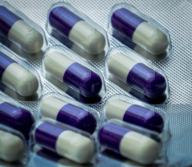 Fluconazole : Antifungal medicine. Full frame picture of purple, white capsule pills. Healthcare...