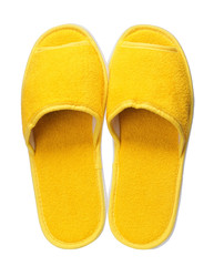 Yellow hotel slippers isolated on white background. Close up, high resolution