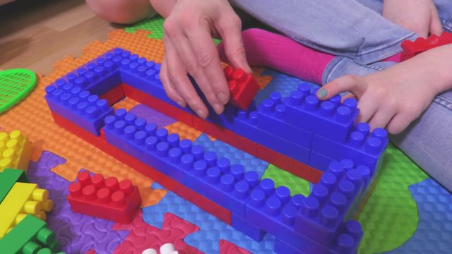 Girl with colorful toy bricks