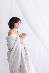 Fototapeta premium portrait Caucasian girl blanket bare shoulders coffee