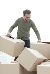 confident man unpacking boxes in the new house