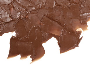 Melted chocolate spreading isolated on white background, top view