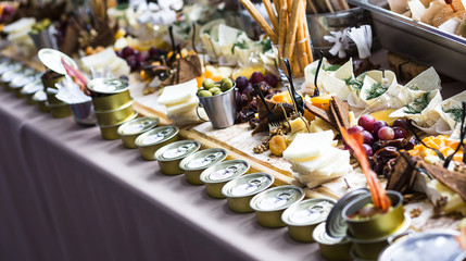 holiday buffet table served by different canape, sandwiches, snacks ready for eating in restaurant