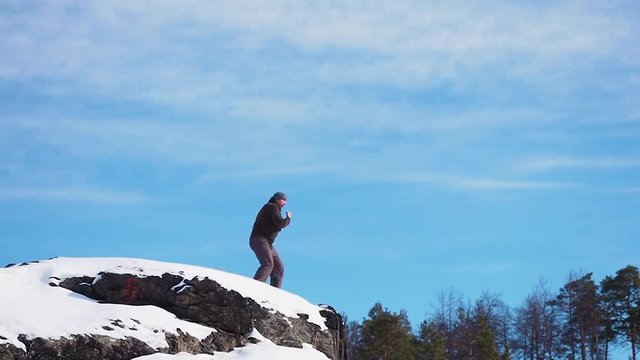 boxer trains on a rock at Maryland Heights while looking at the view of Harpers Ferry National Park and the Potomac and Shenandoah Rivers