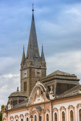 Fototapeta na wymiar Baroque building and church tower in Turda, Romania