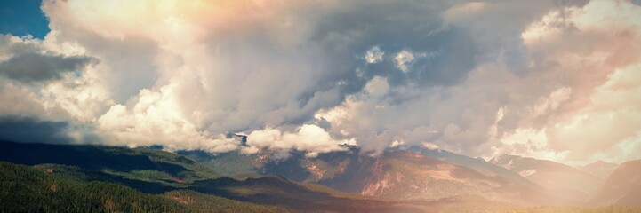 Cloudy sky over green mountains and river