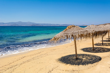 Umbrellas on beautiful sandy Agia Anna beach. Naxos island. Greece - obrazy, fototapety, plakaty