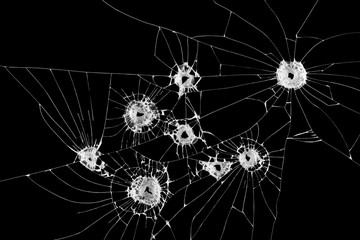 Eight bullet holes on window isolated on black background.
