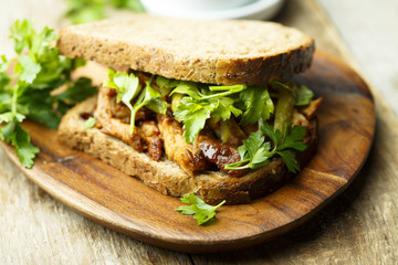 BBQ chicken sandwich on a dark rye bread