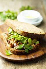 BBQ chicken sandwich on a dark rye bread