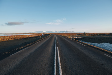 empty asphalt road and beautiful mountains on horizon in iceland
