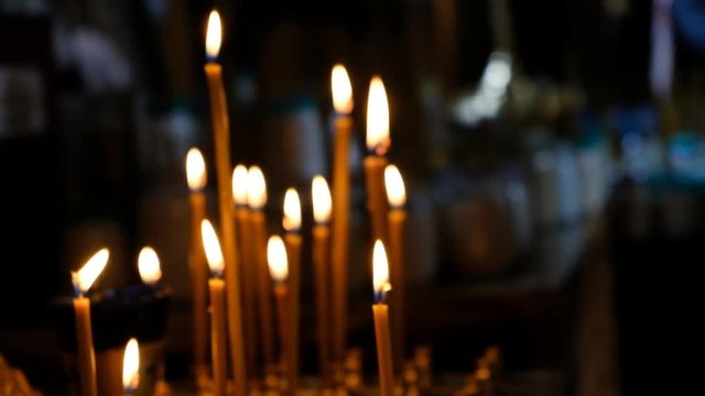 Candles burn in the temple on a religious holiday.