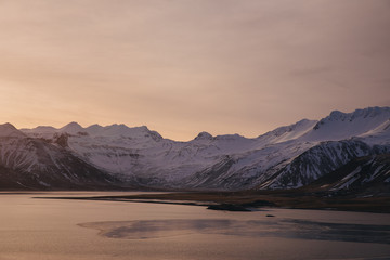 Fototapeta na wymiar majestic icelandic landscape with snow-covered mountains at sunset