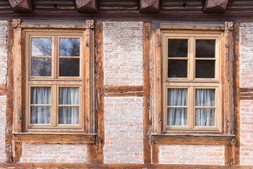 Fototapeta na wymiar Two windows in an old half timbered house