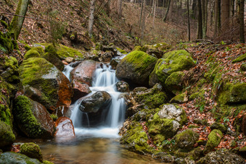 waterfall with silk water and green grass 