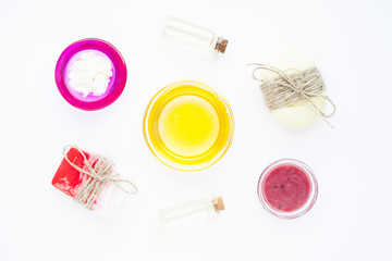Natural herbal skin care products. Top view ingredients honey, sea salt, berries, oil and soap on the white background. Medical care, spa, beauty, health concept. 
