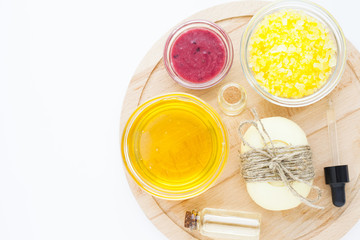 Natural herbal skin care products. Top view ingredients honey, sea salt, berries, oil and soap on the white background. Medical care, spa, beauty, health concept. 