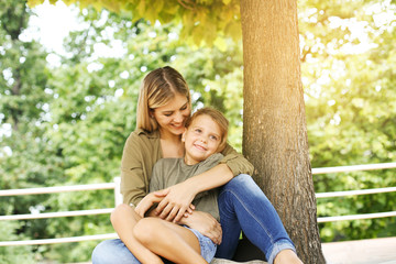 Fototapeta premium Cheerful mother with her daughter outdoor.