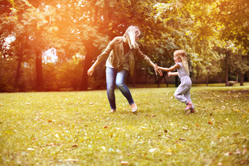 Mother and daughter playing in the park.