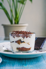 Homemade Italian dessert tiramisu and coffee on the table by the window