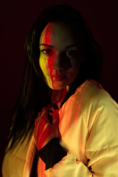 Pretty stylish woman with light on face