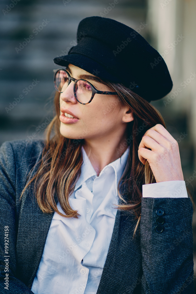 Wall mural Head shot of beautiful brunette wearing glasses.