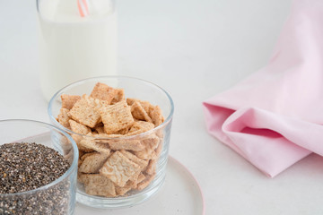 Healthy breakfast in the cups of chia, cereals, nuts and milk. The concept of healthy eating.