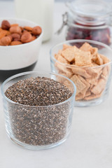 Healthy breakfast in the cups of chia, cereals, nuts and milk. The concept of healthy eating.