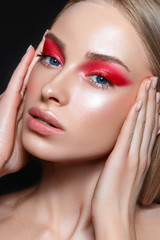 Beautiful woman portrait with red eyeshadows.