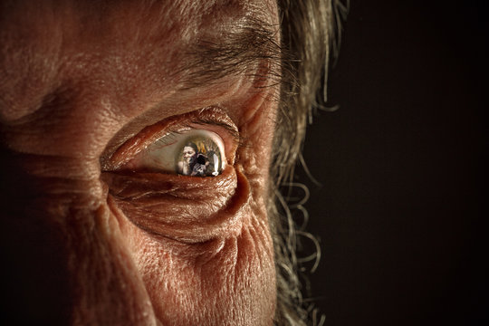 Half face of aggressive man looking with hatred into camera, domestic tyrant