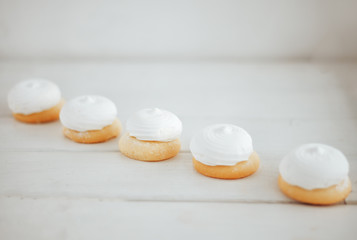 closeup white zephyr cookies lie to the line on white wooden background