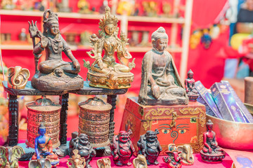 Ethnic objects on a stand. Ornamental gold statuettes representing ethnic, Indian, Hindu and Buddhist deities