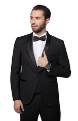 Shark of capitalism. Young male businessman showing. He is dressed in a strict black suit. Rich.