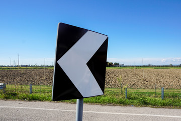 road signs indicating direction on curved road