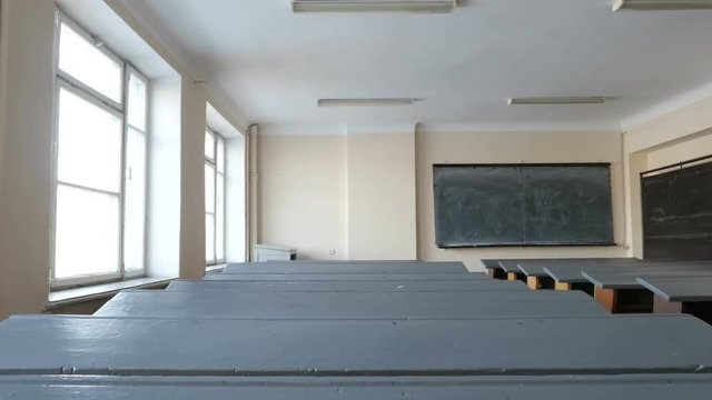 Desks in empty classroom, lecture hall in the College, School, University. The study hall represents lack of state funding
