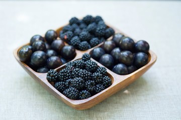 fruits of plums and blackberries