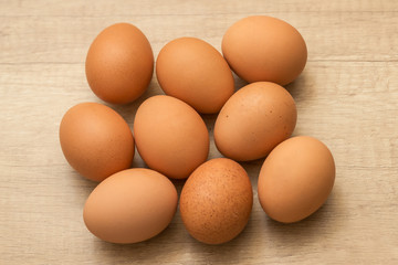 many raw chicken eggs  on a wooden background

